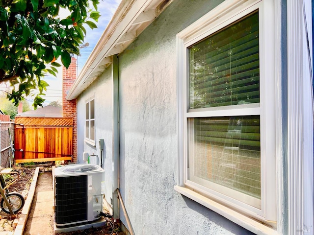 exterior space featuring cooling unit and fence