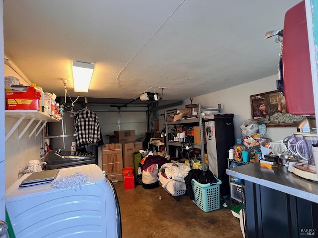 garage featuring a garage door opener and washer and dryer