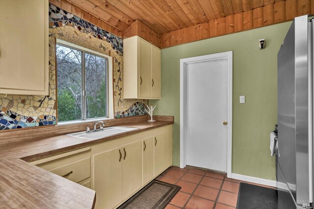 14031 Ettawa Springs Rd, Middletown, CA 95461 - kitchen featuring decorative backsplash, freestanding refrigerator, a sink, tile patterned flooring, and wooden ceiling
