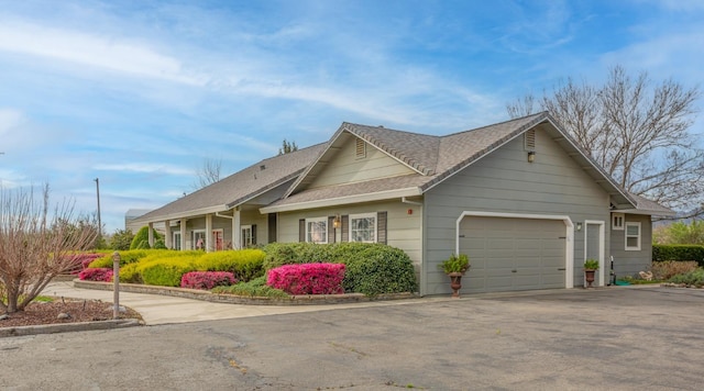 view of front of house with a garage and aphalt driveway
