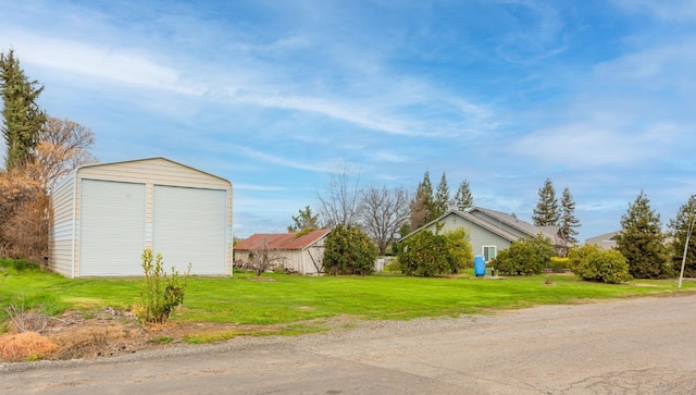 view of yard with an outdoor structure, a garage, and a pole building