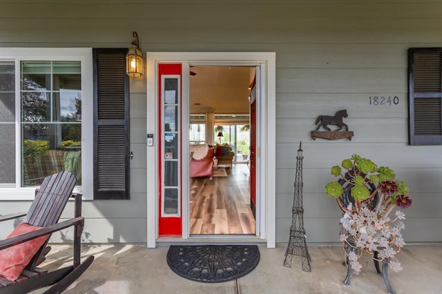 view of exterior entry with covered porch