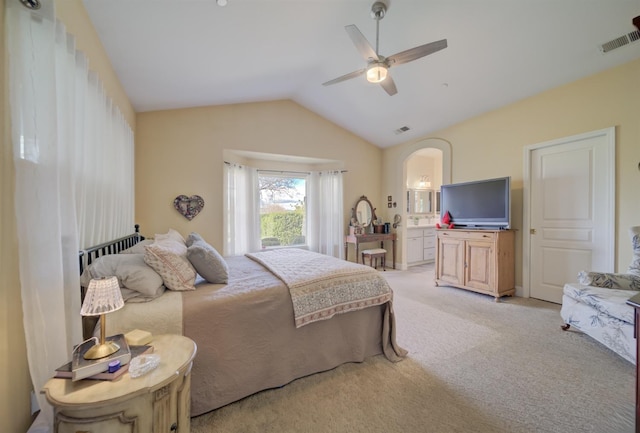 bedroom featuring vaulted ceiling, arched walkways, ceiling fan, visible vents, and light carpet