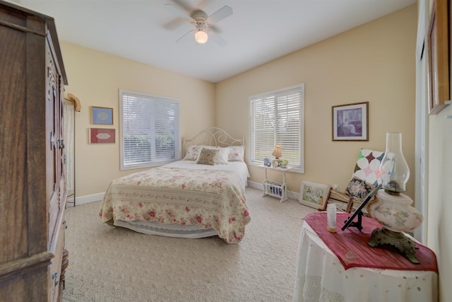 carpeted bedroom with baseboards and ceiling fan