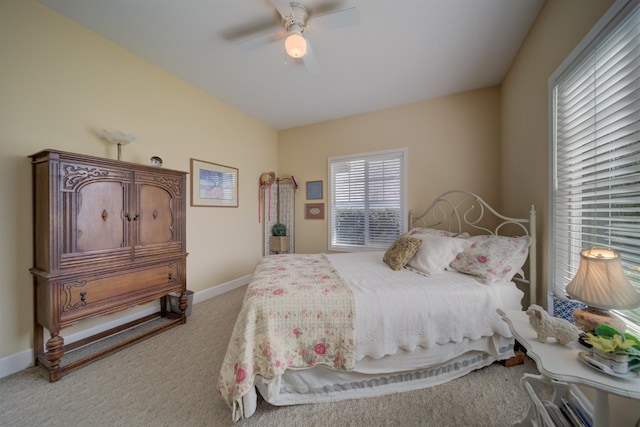 bedroom with baseboards, carpet floors, and a ceiling fan