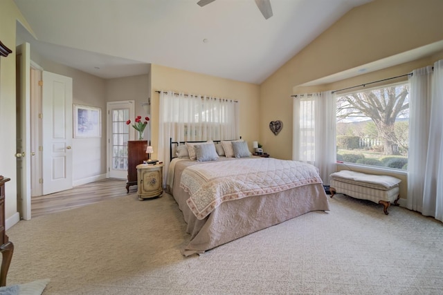carpeted bedroom featuring baseboards, vaulted ceiling, and ceiling fan