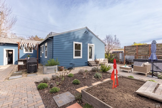 back of property with a patio, fence, and an outdoor living space