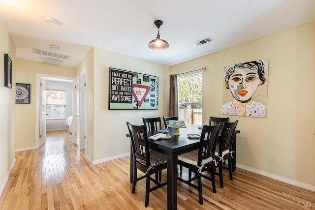 dining space with light wood-style flooring, plenty of natural light, visible vents, and baseboards