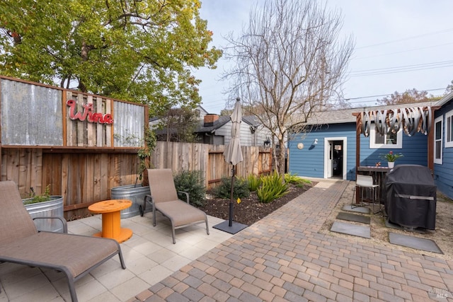 view of patio / terrace featuring a grill and fence