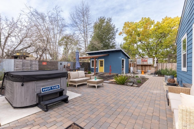 view of patio / terrace featuring outdoor lounge area, a fenced backyard, and a hot tub