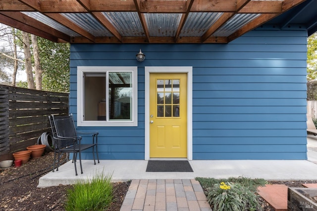 entrance to property featuring fence