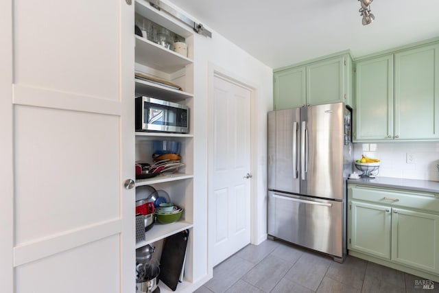 kitchen featuring open shelves, appliances with stainless steel finishes, decorative backsplash, and green cabinetry