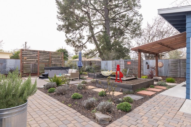 view of patio / terrace with a fenced backyard and a hot tub