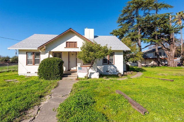 bungalow-style home featuring a chimney, stucco siding, a front lawn, and crawl space