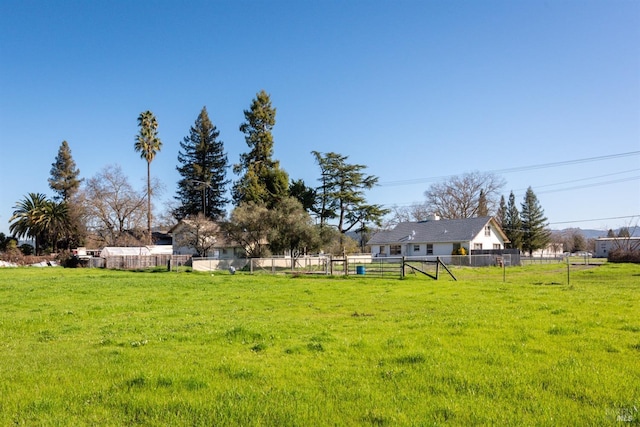 view of yard featuring a rural view and fence