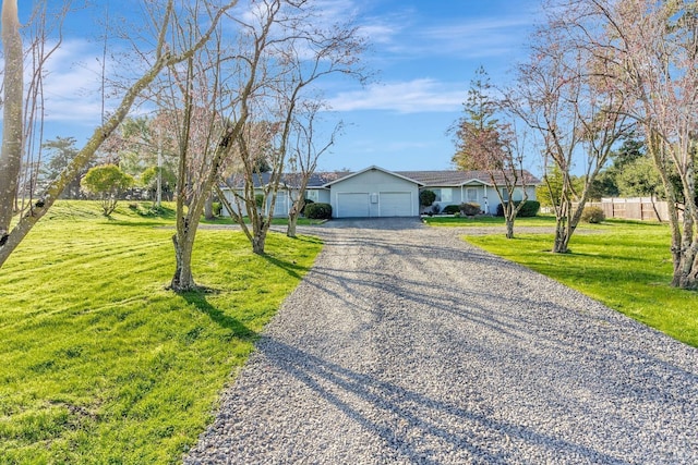 ranch-style house featuring driveway, a front lawn, an attached garage, and fence