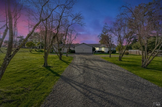 view of front facade featuring a garage, driveway, and a front yard