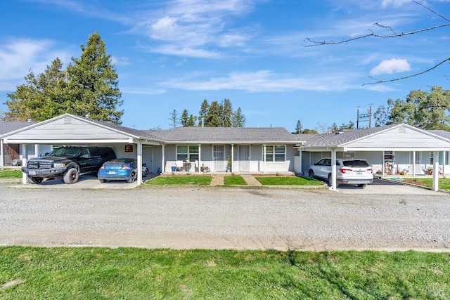 ranch-style house featuring a carport and driveway