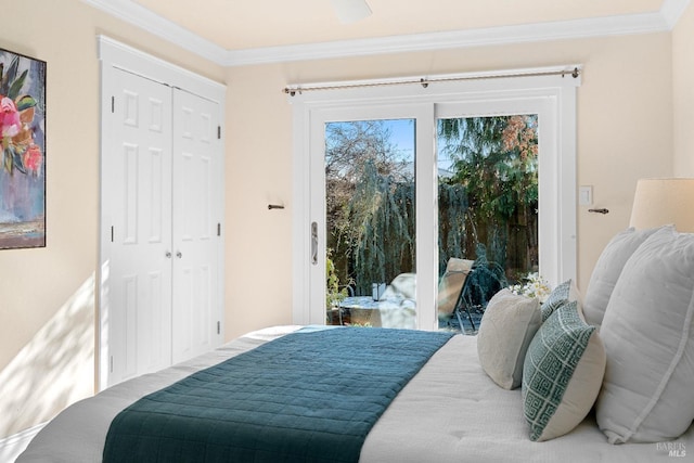 bedroom featuring access to outside, a closet, and crown molding