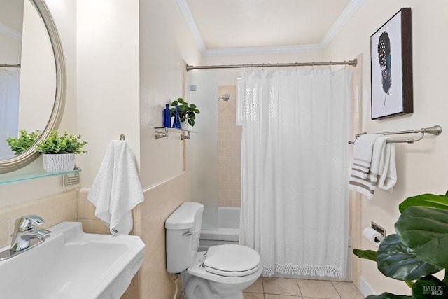 bathroom with toilet, ornamental molding, a sink, and tile patterned floors