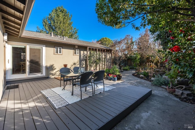 wooden deck featuring outdoor dining area