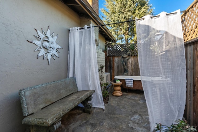 view of patio / terrace featuring fence