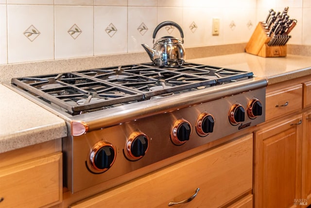 room details featuring stainless steel gas cooktop and light countertops