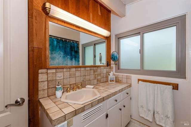 bathroom featuring backsplash and vanity