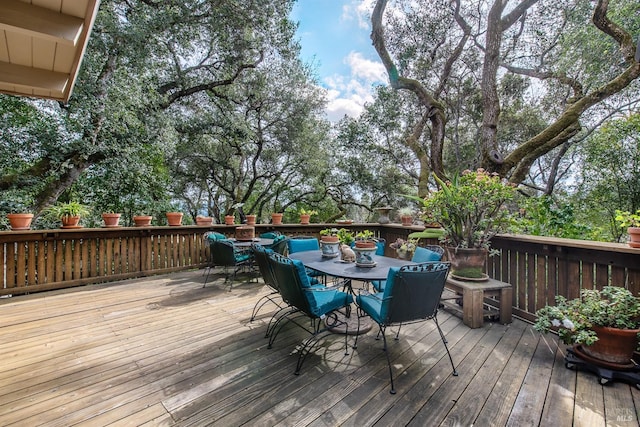 wooden terrace with outdoor dining space