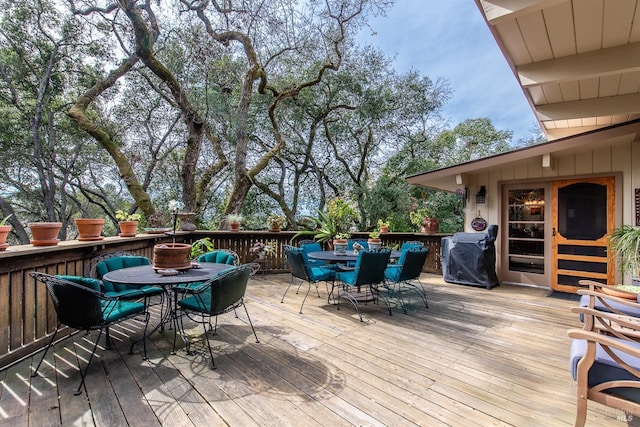 wooden terrace with outdoor dining area