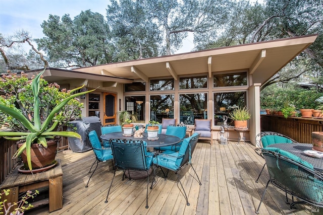 wooden terrace with outdoor dining area