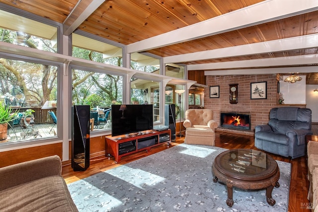 living area featuring wooden ceiling, a fireplace, beamed ceiling, and wood finished floors