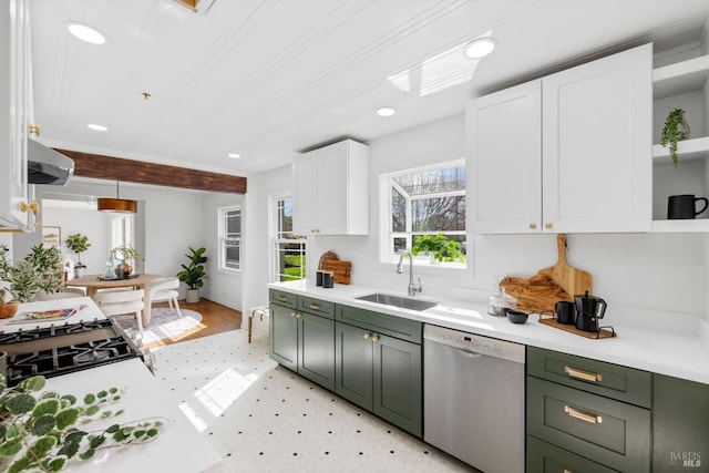 kitchen with dishwasher, open shelves, green cabinets, and a sink