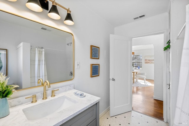 bathroom featuring curtained shower, tile patterned floors, visible vents, and vanity