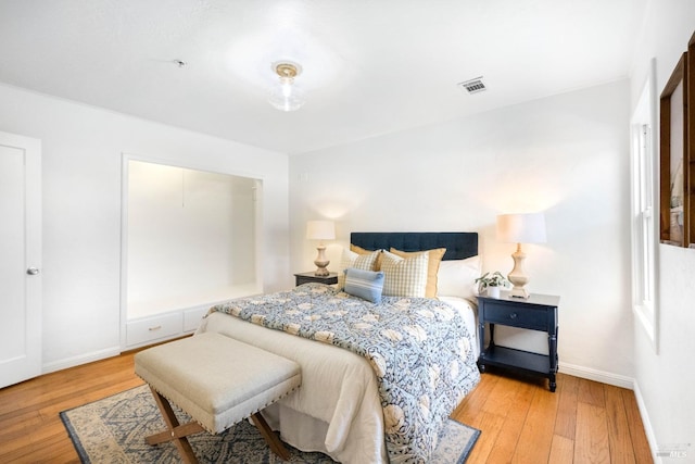 bedroom featuring baseboards and hardwood / wood-style floors