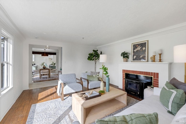 living area featuring a textured ceiling, ornamental molding, and wood finished floors