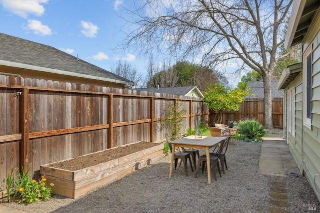 view of patio with a fenced backyard and outdoor dining space