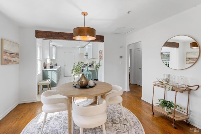 dining room with light wood-style flooring and baseboards