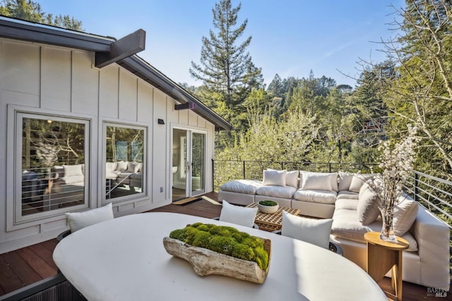 wooden terrace with an outdoor hangout area