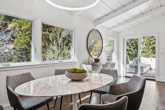 dining room featuring vaulted ceiling with beams and wood finished floors