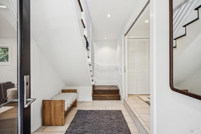 entryway featuring light tile patterned floors, stairs, baseboards, and recessed lighting