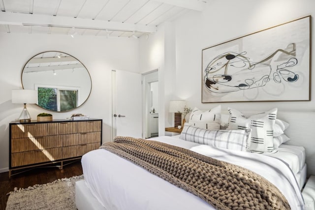 bedroom featuring wood ceiling, wood finished floors, rail lighting, and vaulted ceiling with beams