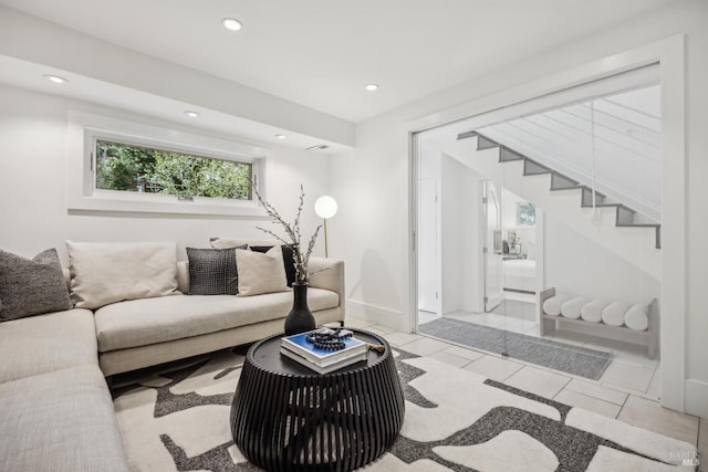 tiled living room with stairs, baseboards, and recessed lighting