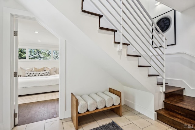 stairway with tile patterned flooring