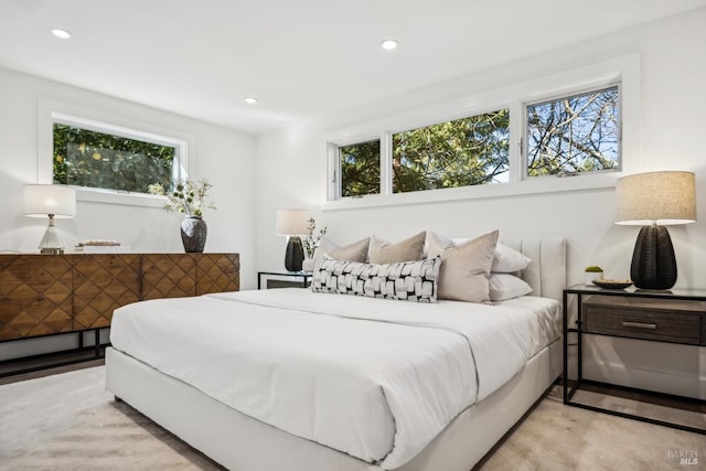 bedroom with a baseboard radiator and recessed lighting