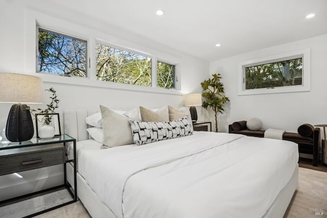 bedroom with light wood-style floors and recessed lighting