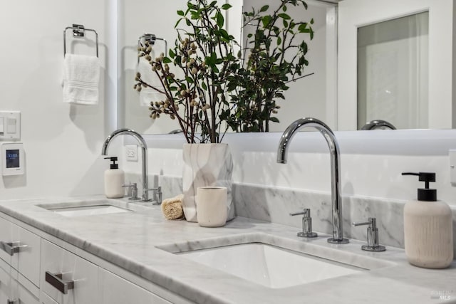 details with a sink, backsplash, and double vanity