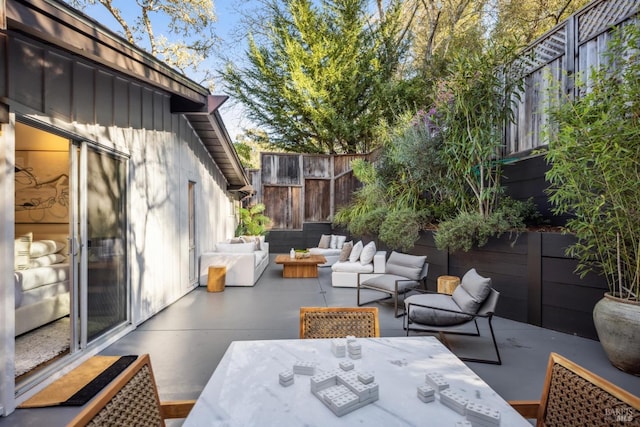 view of patio / terrace with an outdoor hangout area, outdoor dining area, and fence