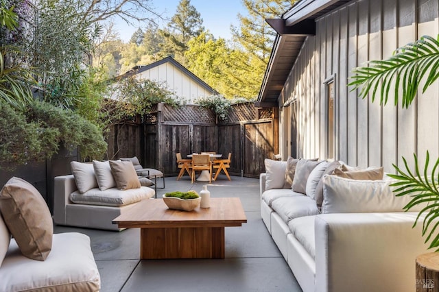 view of patio featuring an outdoor hangout area, outdoor dining area, and fence