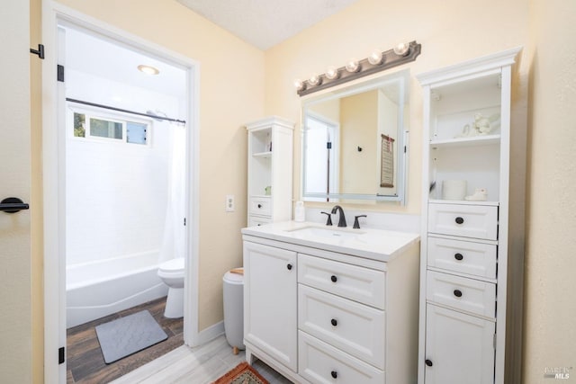 full bathroom featuring toilet, shower / tub combo, wood finished floors, and vanity